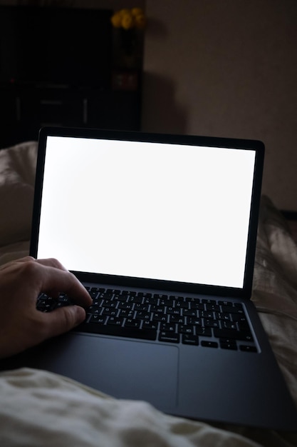 Laptop white screen working in bed copy space point of view