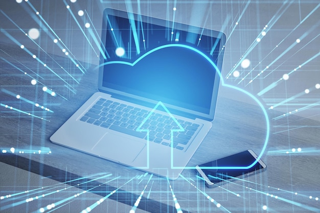 Laptop with abstract glowing cloud and digital blue mesh hologram on blurry desk background Safety and secure concept Double exposure