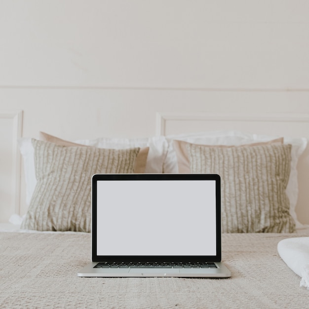 Laptop with blank screen display in bed