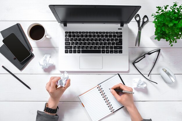 Laptop with blank screen and girl's hands. Flat lay, top view workspace. Copy space