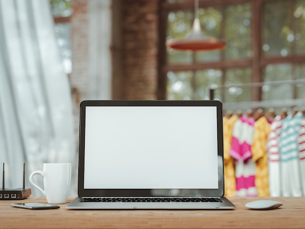 Laptop with blank screen on table.The atmosphere in the Office. 3d render and illustration.