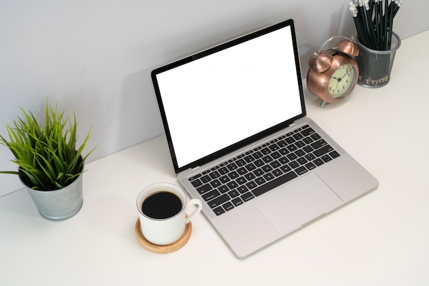 Laptop with blank screen on table, Top view shot