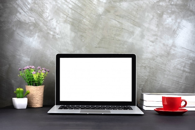 Laptop with blank screen on table