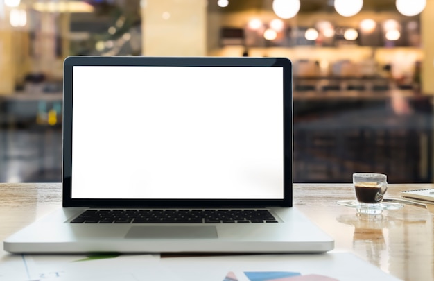 Laptop with blank screen on table.