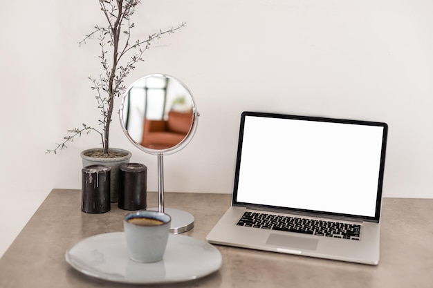 Laptop with blank screen on table.