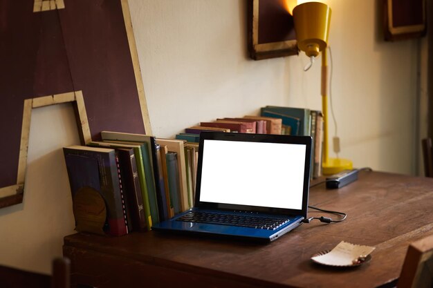 Photo laptop with blank screen on wood table with vintage display office