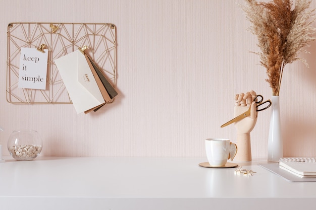 Photo laptop with blank white screen on office desk interior. stylish gold workplace mockup table view.