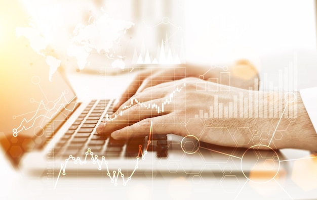 Laptop with business graphs toning