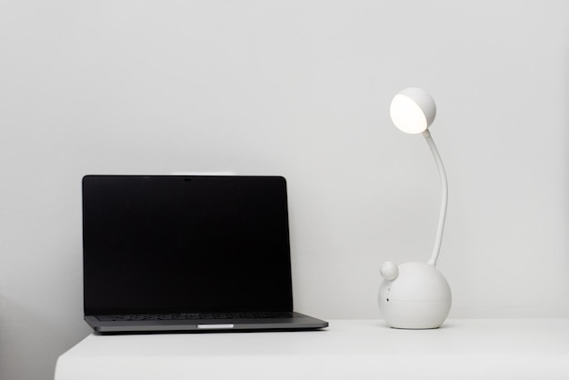 laptop with clock and mobile phone on the white background