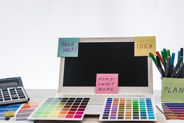 Laptop with designer color swatches on the working place.