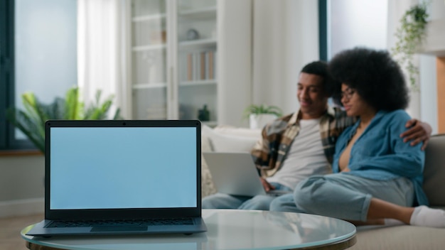 Laptop with empty copy space gray blue screen advertise ads template on foreground african american