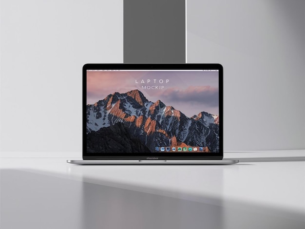 Photo a laptop with a mountain on the screen and the screen showing the mountain range