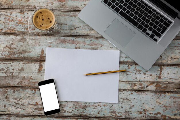 Laptop with smartphone and cup of coffee