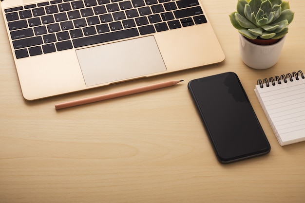 Laptop with smartphone on office desk