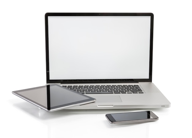 Laptop with tablet by phone against white background