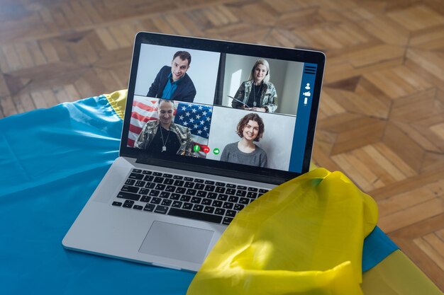 Laptop with video conference near the flag of ukraine