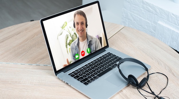 Photo laptop with videoconference stands on the table.