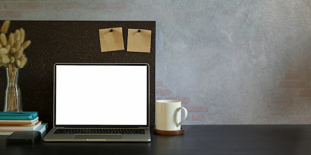 Laptop with white blank screen on a table