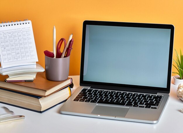 A laptop with a white calendar next to it