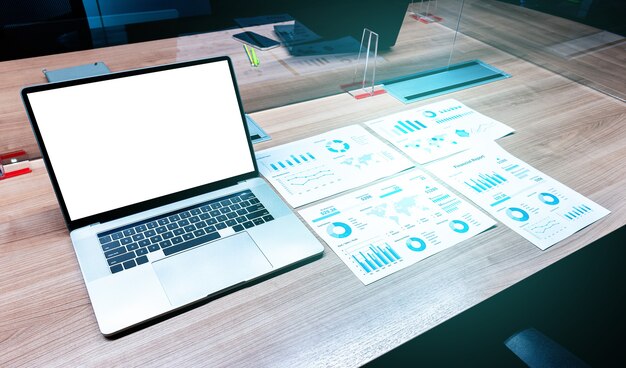 Laptop with white screen mock up and paperwork on table