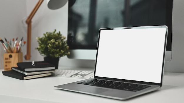 A laptop with white screen on modern workspace