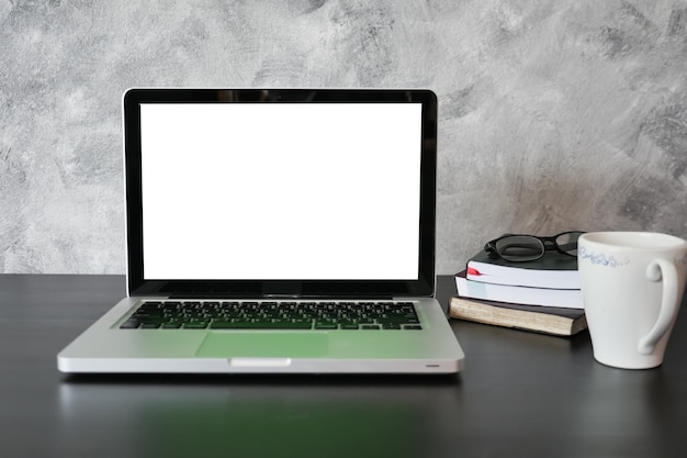 Laptop with white screen monitor on the desk.