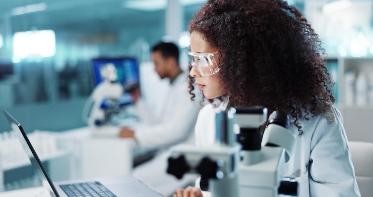 Photo laptop woman or scientist with microscope or research in lab for chemistry report or medical test feedback bacteria person typing or science update for online medicine development news on website
