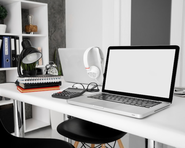 Laptops with notebooks and calculator on office desk