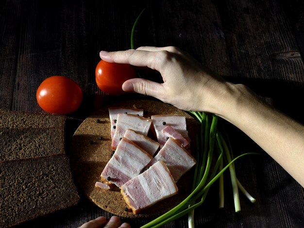 Lard with black bread and green onions on a dark background Russian national food