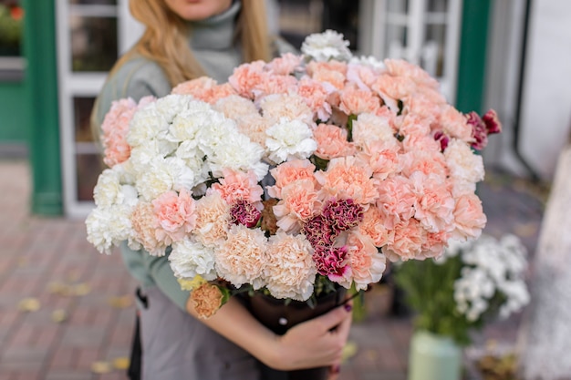 Large beautiful bouquet of mixed flowers in woman hand.