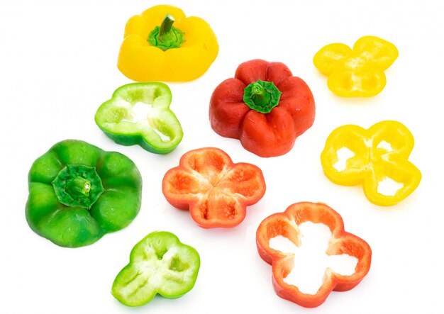 Large bell pepper slices green and yellow on white background