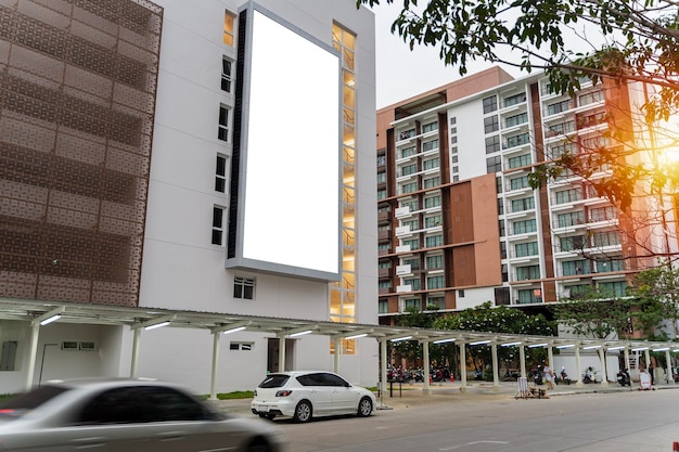 A large blank billboard on a street wall signboard with room to add your own message Empty white poster on city building