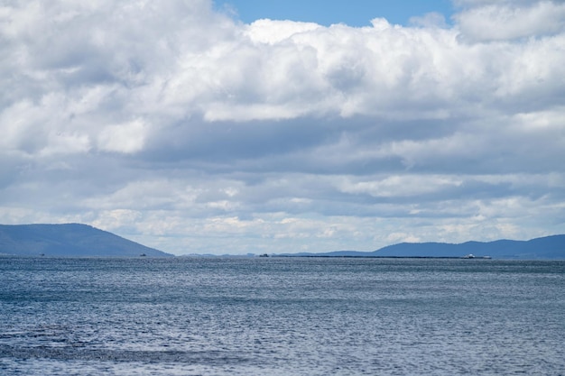 A large body of water with a mountain in the background.