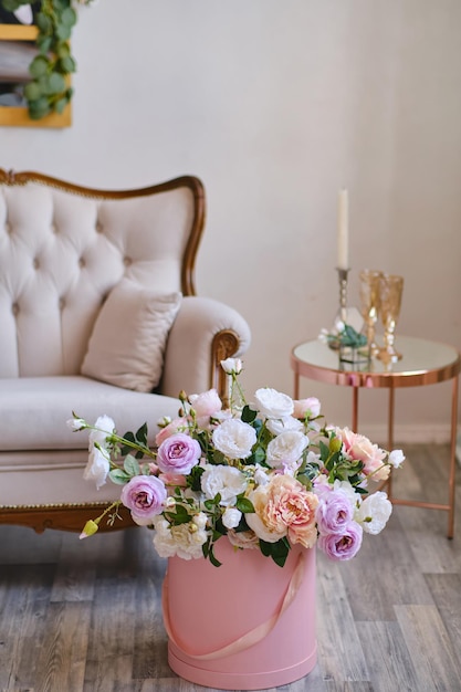 Large bouquet of decorative flowers in a pink hat box