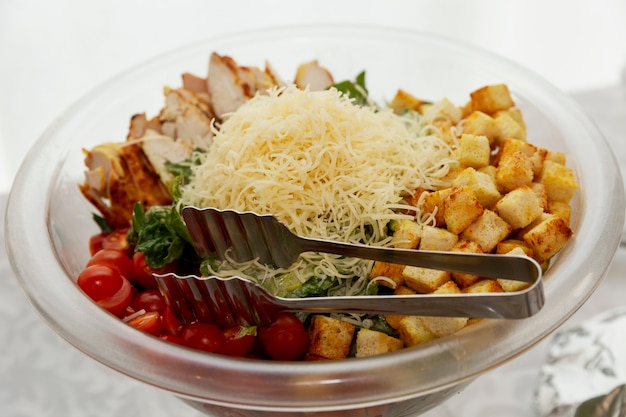 A large bowl of salad on the buffet table. Catering for business meetings, events and celebrations.