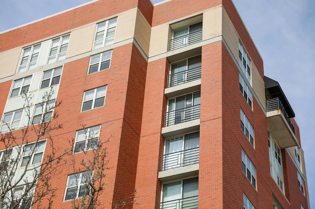 A large brick building with balconies and a balcony on the side.