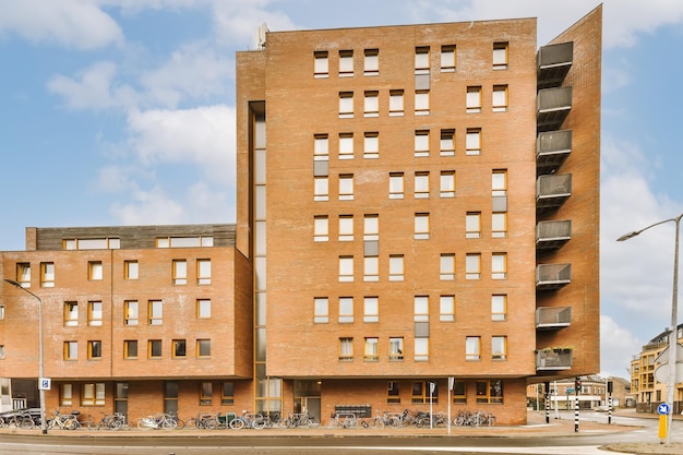 A large brick building with bicycles parked outside of it