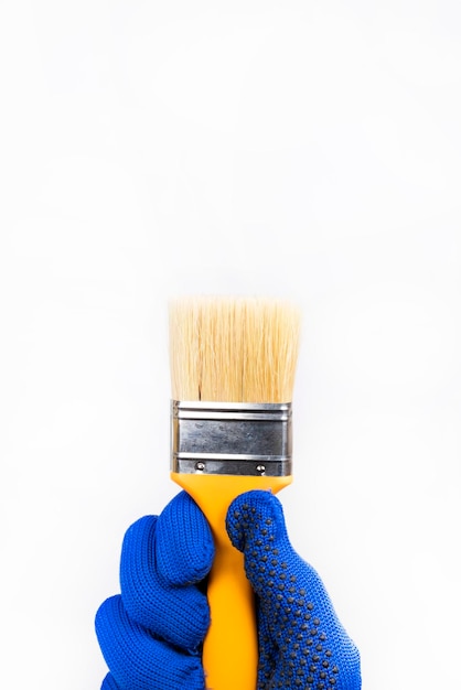 Large brush with orange handle, on white background