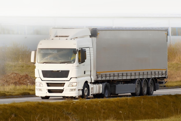 Large cargo truck traveling on asphalt road