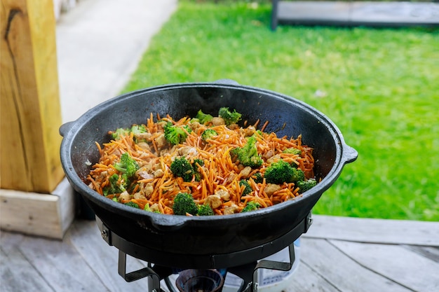 A large cauldron with a cooked healthy vegetable for party outdoor.