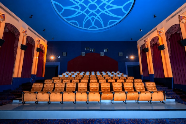 Large cinema theater with empty chair movie seats.