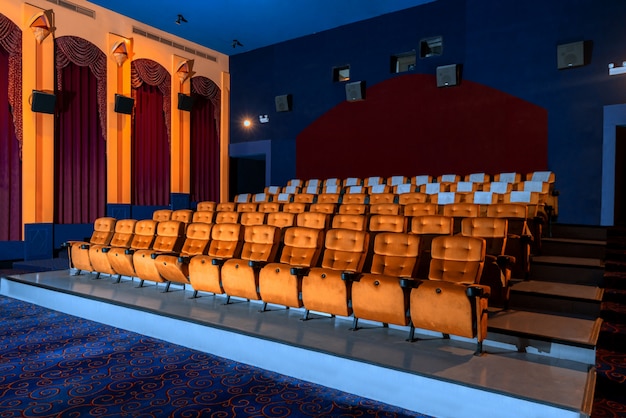 Large cinema theater with empty chair movie seats.