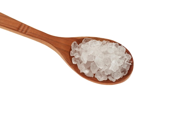 Large Citric acid salt or Lemon salt crystals in wooden spoon on white background Design element