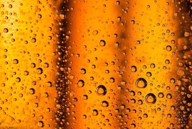 A large closeup of chilled beer technology with drops