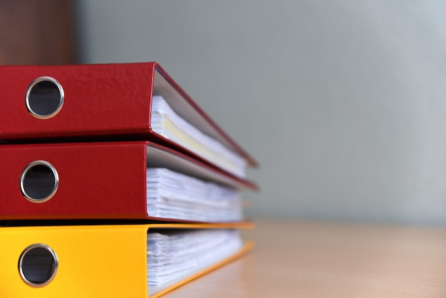 Large color folders for documents on the table in the office, close-up, copy space