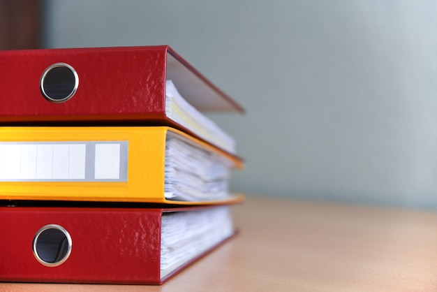 Large color folders for documents on the table in the office, close-up, copy space