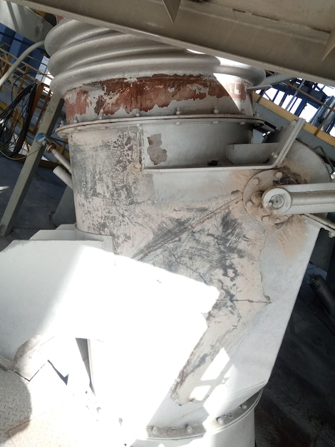 A large concrete mixer with a white spot on the side.