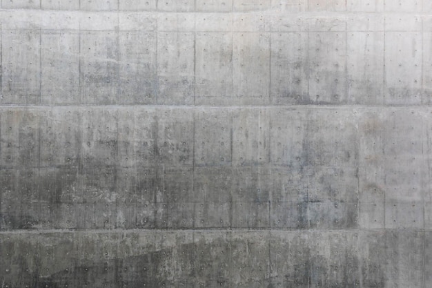 A large concrete wall with a gray background and the word concrete