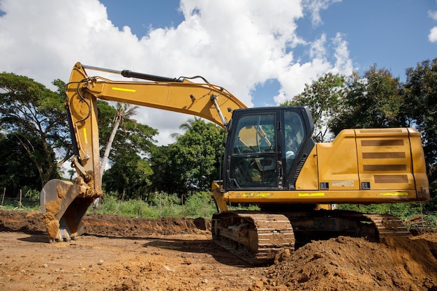 A large construction excavator of yellow color on the construction site in a quarry for quarrying