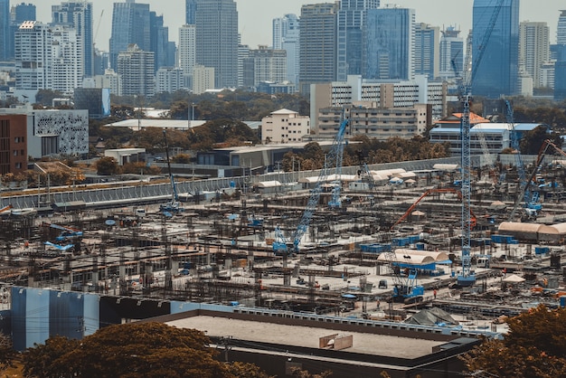 Large construction site with heavy construction machinery in metropolis